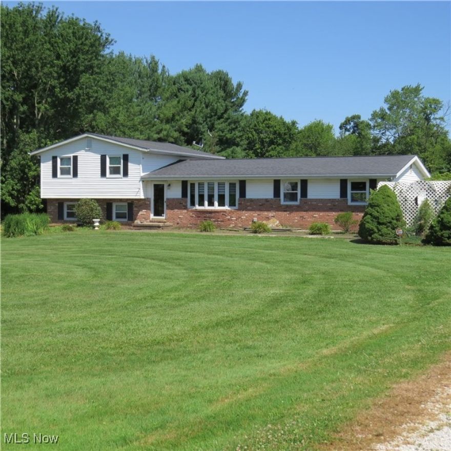 Country 4-Bedroom Split Level Home on 5 Acres! Great location that's only minutes to Canton, Atwood Lake and Lake Mohawk. Level, open lot with easy road access. A well-maintained 1976 home with 1 1/2 or 2 baths, large living and family rooms, basement level with laundry, covered rear patio off of the dining area, attached 2-car garage, and detached 1999 24'x32' garage that would make an awesome workshop or toy storage. Updates include replacement windows and whole house backup generator with owned propane tank. No zoning nor restrictions here. You can see plentiful wildlife, and animals are allowed to start a mini farm, etc. There are some woods at the northern end of the property. Plenty of room to enjoy the outdoors and have a fire under the stars at night. Minerals do not transfer. A new septic system is ready for installation. Call to schedule your viewing!