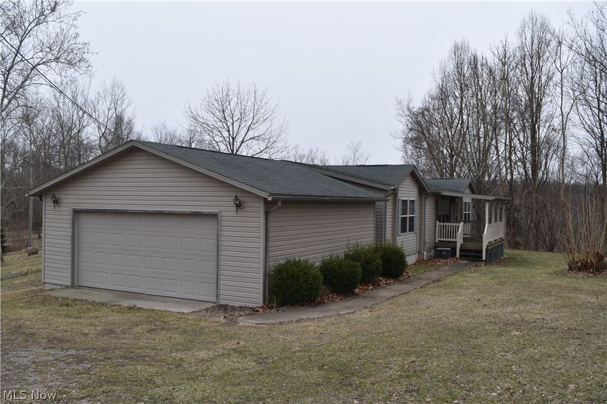 Wonderful double wide home nestled in a wooded setting on 15+ acres with a beautiful pond and even includes a deer stand. The home offers 3 bedrooms and 2 full baths plus a nice 2 car detached garage. Just 5 minutes from I-70. Run don't walk to this one because it will sell fast. Sellers had a well drilled but the water is bad. They have a cistern and water has to be delivered.