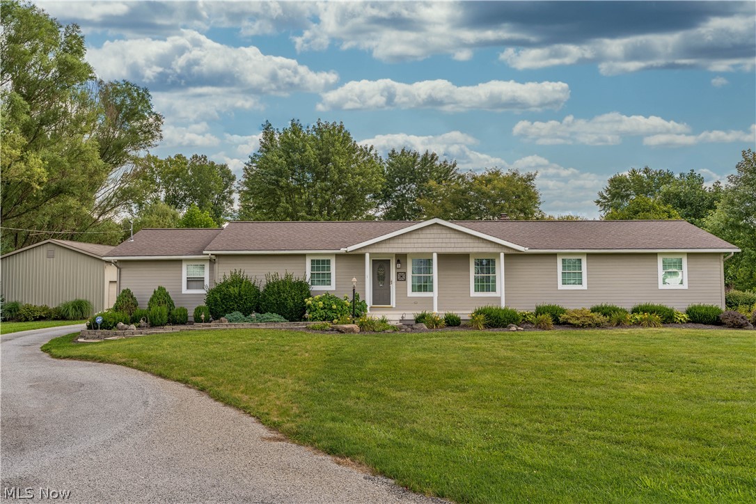 Serene country setting for this Marlboro Twp ranch on 2.54 acres. Peaceful back yard goes out to a stream and a pond, and has an adorable storage shed with front porch. The 50 x 24 garage/workshop can hold 4 cars, one of the overhead doors can accommodate an RV. It has a gas heater, 240 volts electric, and a 44x14 lean-to on the backside. This well maintained and updated home offers a formal living room that opens to the dining room and kitchen. Loads of cupboards and counter space in the light and bright kitchen featuring a breakfast bar and a full wall built-in china cabinet. The family room with a built-in cherry entertainment center is open to the light filled sun room, which offers views of the backyard and accesses the expansive back porch. Three bedrooms and two full bathrooms include the master suite with a walk-in closet, and a full bath offering a double vanity and walk-in shower. The attached 2 plus car garage accesses the convenient mudroom with a double coat closet, a half