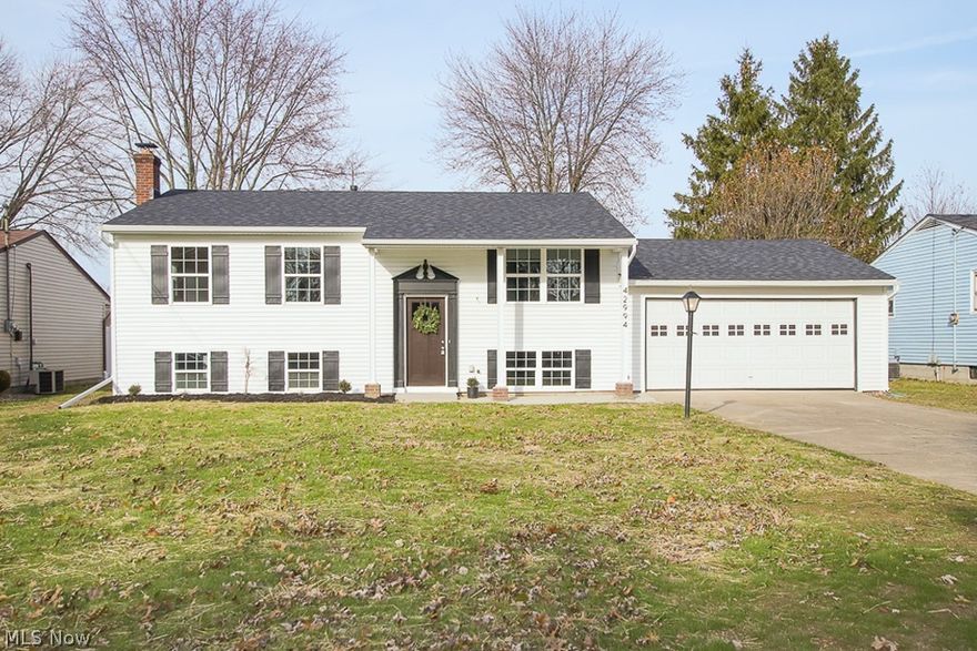 INCREDIBLE makeover in 2019! Eye catching curb appeal + light & airy interior appeal! The list of updates goes on and on! Exterior updates '19 include: vinyl siding & windows, gutters, roof, front porch/walk. Beautiful foyer entry complete with a gorgeous front door, designer floor tile. Open concept living room with refinished hardwood flooring and wide base trim. Remodeled kitchen ('19) complete with stainless steel appliances, breakfast bar, pendant lighting. Updated full bathroom; new tub/suround,vanity, commode. All bedrooms have hardwood flooring. New trim and doors throughout! Lower level is complete with a fourth bedroom, full updated bathroom with walk in shower. There's also a spacious L-shaped family room complete with a woodburning stove! Side note: there is NO carpet in this home, all hardwood or vinyl flooring! Spacious laundry/storage room. 2 car attached garage. Fenced yard, storage shed. Oh, and MORE big ticket items replaced in 2019; Furnace, h20 tank, central air, se