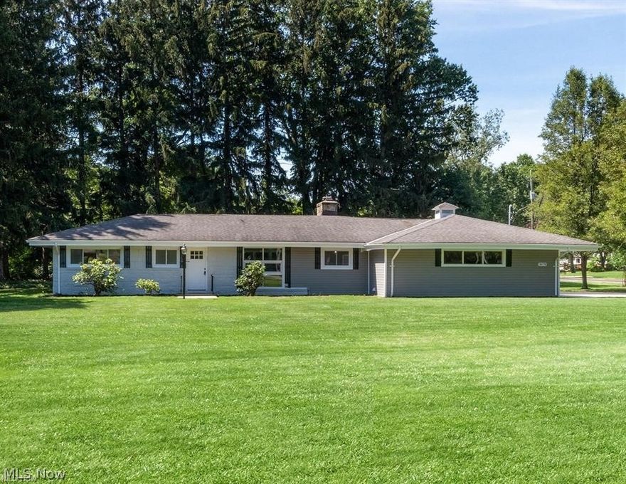 Discover this beautifully transformed, spacious ranch in sought-after South Mentor, perfectly situated on over an acre of private land! This 1,600+ square foot, fully renovated home delivers effortless one-floor living with a bright, modern feel throughout. Step inside to a thoughtfully updated interior featuring warm neutral tones and an inviting layout. The stunning kitchen shines with crisp Shaker cabinetry, classic subway tile backsplash, sleek granite countertops, and a large center island, ideal for gathering. Top-of-the-line stainless steel appliances complete the space. Both bathrooms have been completely remodeled, including a stylish en-suite in the primary bedroom. The primary suite also offers a versatile bonus room and direct access to the enclosed porch, making it perfect for a private retreat, home office, or potential in-law setup with its own separate entrance. Outside, enjoy entertaining on the spacious patio, along with the convenience of a brand-new circular concrete driveway and an attached two-car garage. The home was completely remodeled in 2021 along with a new HVAC system and windows. The roof, gutters, sump pump, and flooring were installed in 2026.