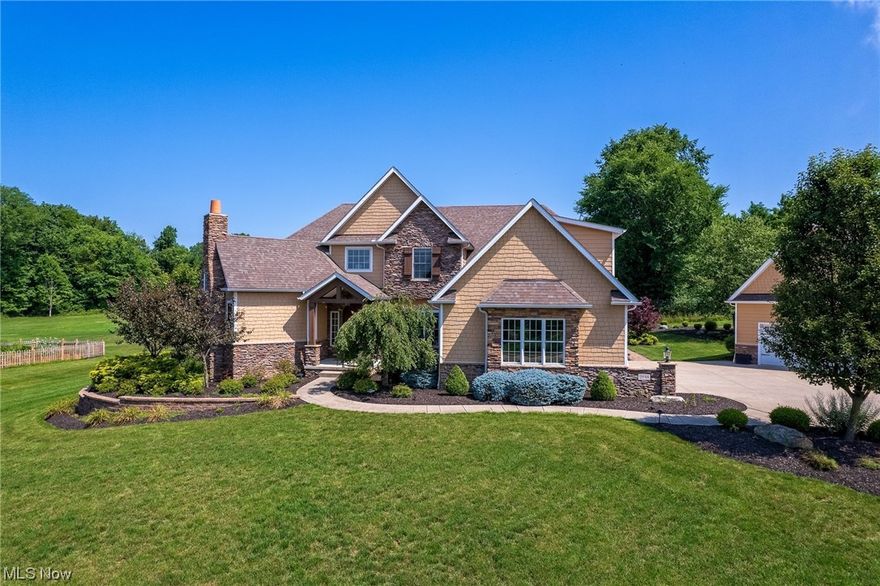 Welcome to this truly magnificent home! Every aspect of this home has been impeccably designed and has craftsmanship well beyond expectations. The moment you enter through the grand front door, you will find yourself surrounded by luxury. From the beam and brick detail on the ceiling, to the stunning fireplace, to the gorgeous floors, you will be in a state of awe. All rooms have been freshly painted except the workout room. The first floor primary bedroom boasts a fabulous bathroom and your very own electric heat sauna. The three season room and hot tub are just a few ways you can enjoy your free time. You'll also find a first floor a beautiful private den with a fireplace. A spectacular finished basement includes a spacious theater room, and an incredible wet bar with granite countertops! Completing this lovely home is a three car attached garage and an additional two car garage/outbuilding with  EV outlet! This home has everything you could ever want...and more!