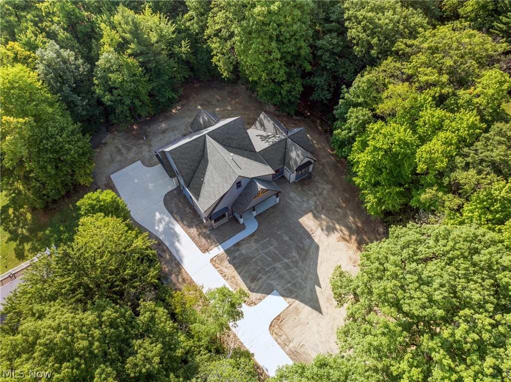 NESTLED IN THE HEART OF ORANGE, THIS NEW CONSTRUCTION HOME WAS JUST COMPLETE! BE ONE OF THE 1ST TO TOUR THIS NEW CONSTRUCTION LUXURY HOME SITUATED ON NEARLY 2 ACRES IN ORANGE! THIS IS TRULY THE MOST STUNNING HOUSE TO HIT THE MARKET IN YEARS. Turnaround concrete driveway to be complete at no additional expense to buyer before closing. 3rd-car garage option and optional finished basement are available also. Introducing a luxury masterpiece in Orange, built by renowned custom luxury builder Dommus Construction. This stunning new construction luxury home boasts unparalleled elegance and sophistication on a sprawling 1.63-acre wooded lot. With over 5,000 square feet of opulent living space (sq footage includes buyer option to finish basement), the 5-bedroom, 3.5-bathroom haven features stunning curb appeal, custom woodwork, modern accents, and meticulous attention to detail. The foyer showcases a floating staircase, and the two-story great room provides the perfect setting for relaxation. The state-of-the-art kitchen is equipped with professional appliances, designer cabinetry, and a stunning stone wall. The spacious dining room and expansive covered porch offer ideal spaces for entertaining and relaxation. The master suite features a private bathroom and ample walk-in closet, while one additional bedroom, a full bathroom, laundry room, first floor office and powder room complete the first floor. The second floor features two spacious bedrooms, a full bathroom, and a loft area overlooking the great room. The unfinished basement offers endless possibilities for customization.