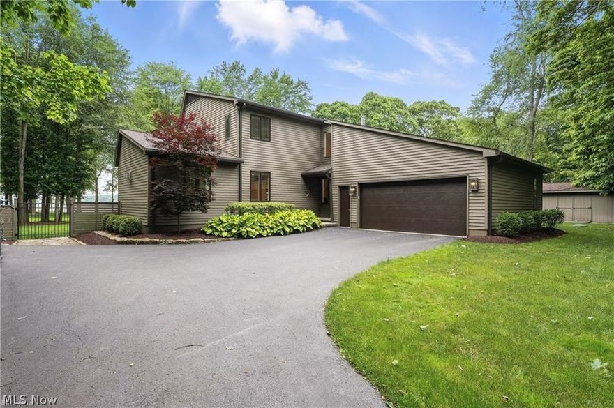 Welcome to your once-in-a-lifetime opportunity to own a stunningly updated contemporary lakefront dream home! This exquisite property on the shores of Pine Lake offers breathtaking panoramic views, unmatched privacy, and year-round tranquility. Surrounded by meticulously landscaped grounds, this home is a true sanctuary, ideal for enjoying all four seasons in style and comfort. Step inside to be greeted by floor-to-ceiling windows spanning the back of the home, perfectly framing spectacular sunsets over the lake. Enjoy these views year-round from the stunning four-season glass room, seamlessly blending indoor and outdoor living. The main level features a cozy family room with a remote-controlled stone gas fireplace, a gourmet kitchen designed for both everyday living and entertaining, and a luxurious first-floor primary suite complete with a spacious walk-in closet, spa-inspired bath, and convenient main-floor laundry. Upstairs, you'll find three additional bedrooms with gorgeous lake views—one featuring its own en-suite bathroom—and a second laundry room, making it perfect for guests or extended family. Car enthusiasts and hobbyists will appreciate the attached two-car garage as well as a newly constructed detached three-car garage, offering ample space for your car collection, lake toys, or workshop. As a property owner, you’ll enjoy privileged lake access, excellent fishing, and the freedom to cruise Pine Lake by boat—all from your own backyard. This home is the ultimate expression of luxury lake living—private, peaceful, and absolutely unforgettable. Don't miss your chance to make it yours.