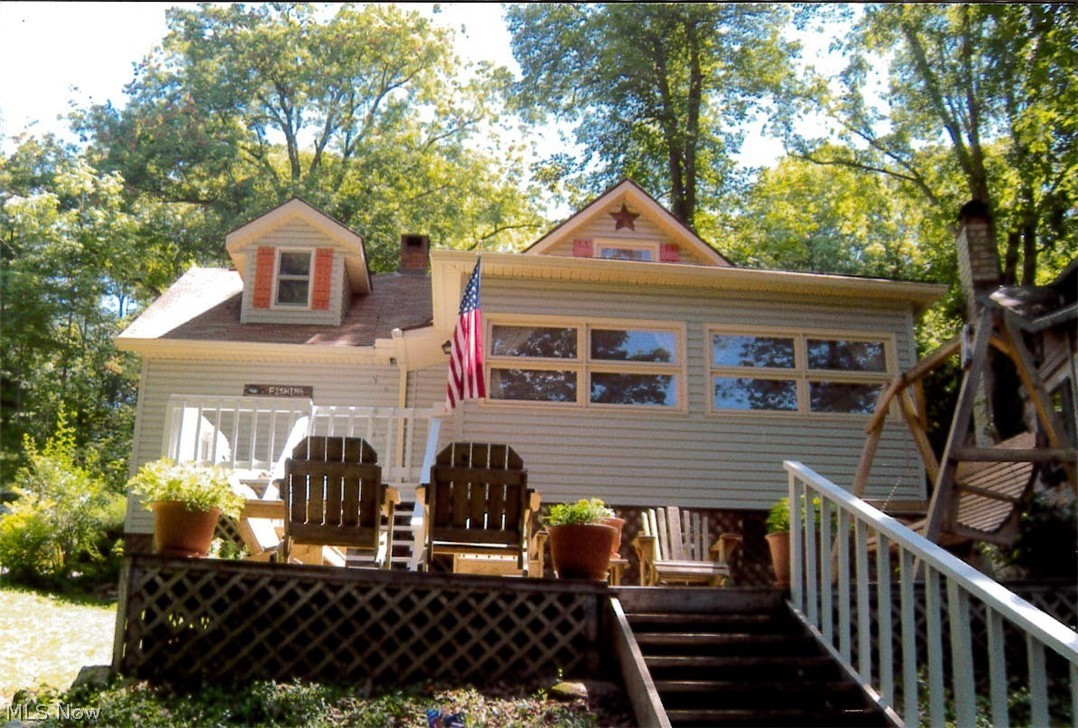 Auction-Saturday, August 17th, 3pm. Lakefront living on stocked-Tabor Lake. Seasonal lake home. Charming vinyl sided 2-3 bedroom cottage. Covered patio. Tastefully decorated throughout. Wood burning brick fireplace. Partial basement. Enjoy views of the water from the home and the 10 X 9 X 10 X 20 decks. Includes furnishings. Lawn mower and paddle boat stays. Includes a dock on the water. Access to 70 acres with 7.5 acre Tabor Lake. No hunting or 4 wheeler on the land. Electric motors only on the water. Stainless steel insulated insert inside the chimney. $450 per year annual membership fee to Tabor Lake Association includes trash pick up, taxes on land and liability insurance. Members do not own the land. Atwood Lake area. Tax card says year built is 1994. Actual year built not verifiable. Sells as is. Com prepared to buy!