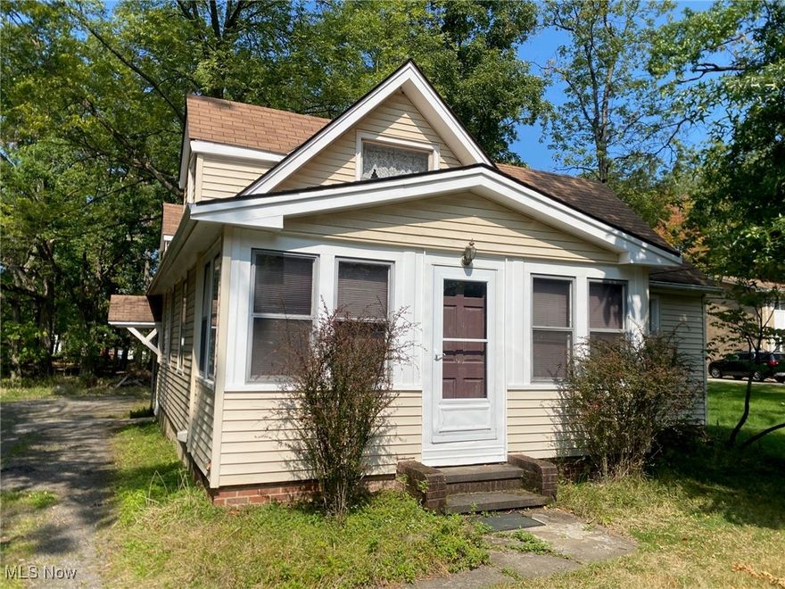 Many possibilities for this seldom available acreage in Parma.  Unique Opportunity in Parma.  1.26 Acres combined property and vacant lots - includes 4 parcels (450-09-017 & 018 & 019 & 020).  Cute Cottage Type home with First Floor Large Master Bedroom.  1-2 Bedrooms on Upper Level with Heat.  Vintage Kitchen with Breakfast Bar & Nook With Pantry, Shelving and Countertop/Desk.  Nice Enclosed Porch with Beautiful Wood Paneling Walls.  One Year Home Warranty.  Refrigerator and Stove Stay.  Enclosed Front Porch.  Creek runs thru back of property.  Septic with leach bed - No sewer hook ups on this street.  Century Home but "not" with Historical Restrictions.  Call Parma City Hall with questions regarding Century status and/or possible future City sewer connection.  Come take a look - Lots of potential!!! Close to Cleveland Hopkins International Airport, Parmatown, Shopping, Restaurants, Entertainment, State Road Park, Metroparks, Southland and I-480 & I-71.