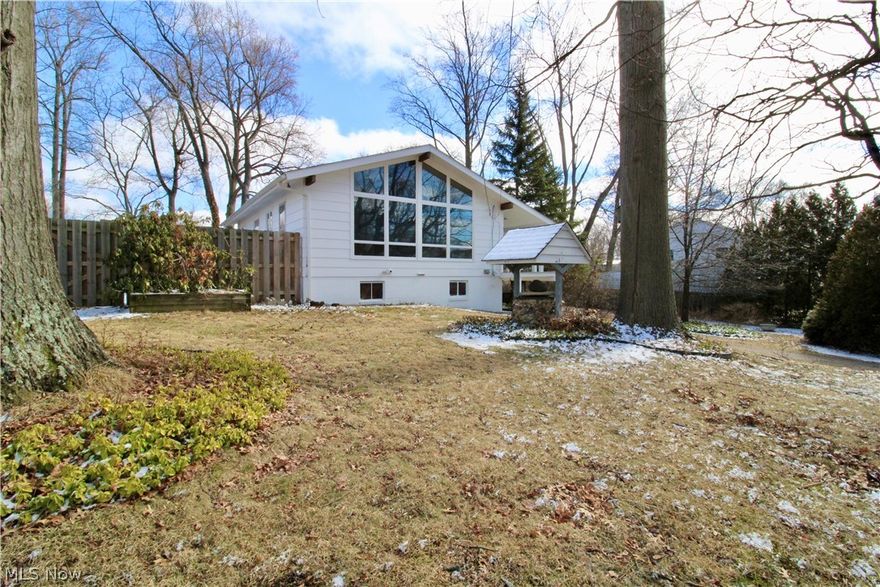 Walk into over 1450 sqft of finished space in this recently renovated home with several updates that keeping its classis mid-century modern charm. Enjoy the rare floor to ceiling vaulted ceilings with windows that illuminate not only the main living area upstars, but  also beams light down to the living space on the ground floor as well. The professionally designed fully renovated kitchen is optimal for entertaining and makes a bold statement that pays homage to the home's original mid-century modern design. This home boasts three well appointed bedrooms and two bright living spaces. The main floor living space can host a formal dining area as well as a sofa and chairs for lounging. The ground level living space currently hosts a large sectional with plenty of extra space to suit your personal needs. This home not only stuns from the inside, but also from the outside space situated on three parcels offering a fully fenced in area as well as a well thought out garden. Bring your fairy garden dreams to life with the beautiful side yard boasting a tiered flowing stone water feature, magical wood swing, a view of japanese maples, perennial garden, arborvitae, rose of sharon, wisteria, and more. This carefully thought out garden always has something in bloom to admire. Close to Osborne Park where you can enjoy views of the lake as well as the many amenities including a playground, pavilions, skate board park, swimming pool, basketball and tennis courts, baseball field, bench/bench swings, disc golf, fishing, and a football field. Some of the updates include: new roof (2022), exterior house paint (2025), Fully remodeled kitchen(2024), carpets (2021), new A/C (2019), Hot water sys (2025), washer/dryer (2019), sump pump (2020) and more!