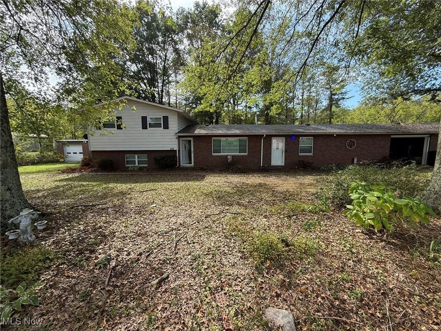 This tri-level home features two garages, each accommodating two cars.  Enjoy living minutes from I-77 but far enough out to escape city life.  The property features a nice, flowing floor plan and a large fenced lot.