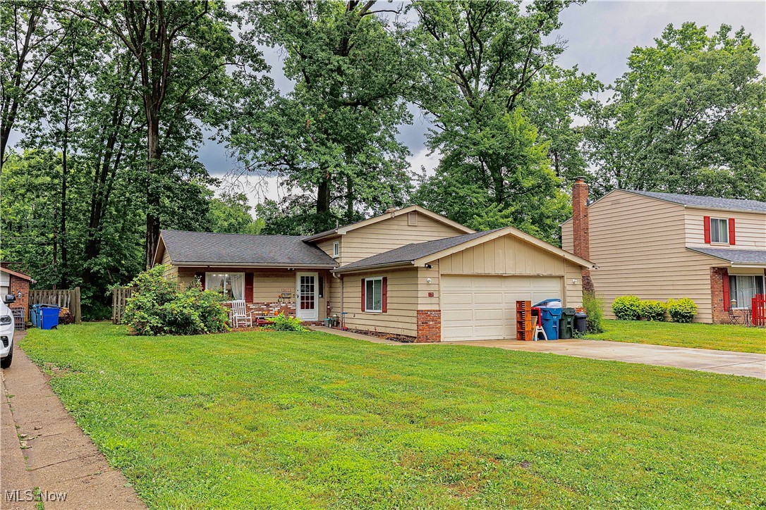 Welcome to this well maintained, move in ready split residence in lovely Olmsted Falls. With neutral flooring and paint throughout. The first floor offers an airy, open layout with vaulted ceilings featuring a chic wood beams, updated modish light fixtures and an oversized glass sliding door leading to the private backyard. The kitchen has been updated with newer cabinetry and includes all appliances. The second level provides 3 bedrooms with ceiling fans and /or light fixtures and a full bath. The lower level boasts a beautiful wall to wall brick fireplace in the family room, full bath and spacious utility room. This home features nice vinyl windows and a full privately fenced back yard. Enjoy the convenient attached 2 car garage. HOA amenities include pool, playground, tennis and basketball courts.