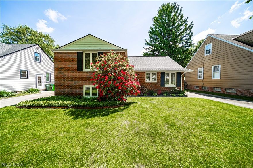 Charming all-brick split-level home boasting two spacious bedrooms and one bath! Hardwood floors flow throughout the interior, adding warmth and character to this already inviting space. The living room features a cozy wood-burning fireplace and large picture window, perfect for taking in the serene views of the backyard. The lower level family room offers a walk-out to the picturesque backyard, complete with a relaxing hot tub (included with the property)! Additional highlights include an oversized detached two-car garage, providing ample storage and parking space. Don't miss out on this wonderful opportunity to make this house your dream home!