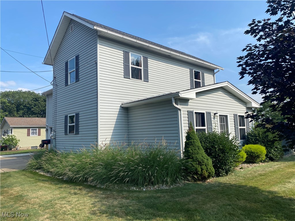 This one-of-a-kind property in New Phila is being offered for sale for the first time in almost 50 years! This home is ideal for multigenerational living or an easy conversion to an up/down duplex. Located on a fenced corner lot with peaceful nature views at the edge of town, the property perfectly blends privacy and practicality. The oversized two-car garage includes heat, a sink, floor drain, and ample lighting. Additional features outside include a workshop shed with power and electric heat, a lawncare shed with lighting, and off-street parking for 7 vehicles including the garage. This home is ready for anything with the included Dual Fuel Whole Home Generator, as well as a One-Time Transferrable Warranty on the roof. Inside, the main level includes a kitchen, living room, laundry closet, and main floor bedroom & bathroom. The bathroom features a stall shower, great counter space, and a brand new LED vanity mirror. Upstairs offers two bedrooms, a full bath with large shower, and an open-concept kitchen/living/dining area with two sliding doors leading to the grand upper deck. Half of the deck is open for full sun, and the other half is covered with gas grill hookups and an outdoor TV mount, the perfect space for summertime entertaining! Accommodations have been made for your four-legged friends a well! A large dog door installed upstairs leads your pets safely to the backyard, which also features an outdoor dog kennel and vinyl coated chain link fence surrounding. Gardeners will love the sunny southern facing back yard! Call today to schedule your private showing!