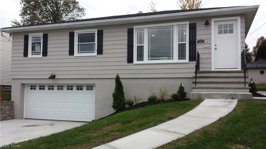 Make this exquisite raised ranch yours today!!! Take in the natural light in this open layout home with a chef's kitchen, large living room with "select" white oak flooring (with 0 VOC finish) that extends into the comfortable sized bedrooms.  Enjoy entertaining friends and family in the open kitchen with beautiful and bright quartz counter tops and white shaker cabinets with dovetailed drawers and soft close hinges!  New electrical and lighting throughout the home, with dimmers in the kitchen and family room allow you to set the mood any time of day.  Renovated first floor bath with gorgeous white subway tile and bead board wainscoting, and added basement level powder room help accommodate guests.  Plenty of room for shoes, coats, and storage in the utility/mudroom with hooks and cubbies! Large, heated, 2 car garage has brand new garage door and opener.  New roof, windows, electrical, furnace, driveway, sidewalks, and retaining wall leave this home absolutely turnkey - truly a site to