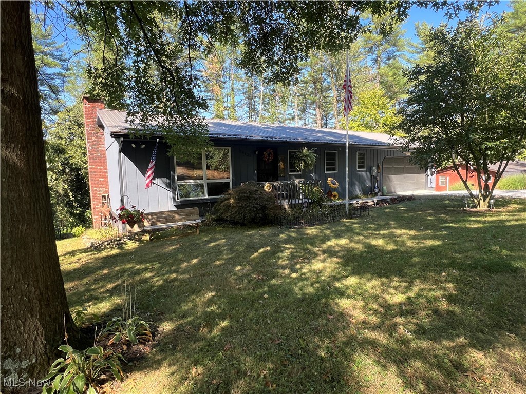 Enjoy lake living on a private setting in this beautiful 3-4 bedroom, 2 bath ranch home. Enjoy seasonal views of Tappan Lake. Original owner. Tastefully updated with fresh paint in 2023, neutral decor and wood laminate flooring and raised panel wood doors. Spacious living room with brick wood burning fireplace and glass doors to the 12 X 23 trex raised deck. Quartz counters in the kitchen with stainless steel appliances. 2nd main floor bedroom currently used as main floor laundry room, includes washer and dryer new in 2023. Brick fireplace in the family room with French doors to the 12 X 23 covered patio. 2 car attached garage and 22 X 12 attached storage area with overhead door. Perfect home for year round living or weekend get-a-way! 2 a/c floor units stay. Anderson thermo windows. New metal roof in 2012. Freshly painted exterior in 2023. New 50 gallon electric hot water heater in 2023. 200 amp electric. Includes new 15,000 generator. Lot T-131. MWCD lease fee of $2,190 annually.