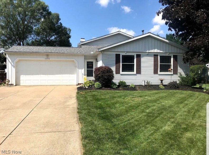 This unique split level has been meticulously maintained with many desirable updates! Almost the entire interior of the home has been professionally painted throughout! Upon entering into the main living area you will see vaulted ceilings which opens to the dining area with beautiful bay windows. Both the dining area and kitchen have brand new laminate flooring. The pristine kitchen boasts white cabinets with backsplash, an extra deep sink and new refrigerator. Upstairs you will find a completely updated full bath with the same new gray laminate flooring, new vanity, light fixture and custom shelving. All 3 bedrooms are upstairs and have newer carpeting as well. The lower level family area has a beautiful brick fireplace and half bath. Take another turn down the stairs to the partially finished basement, also featuring new carpeting, and a full bathroom. In the backyard you will find an inviting covered deck and fenced in backyard. Located in a desirable Twinsburg neighborhood. This on