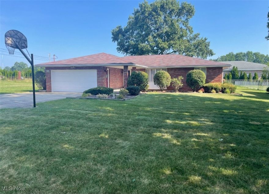 Must see is this 4 bedroom brick ranch home. Features living room with crown molding and bay windows.Huge eat in kitchen with all appliances, island, and plenty of cabinets. Family room with oak trim throughout. 2 1/2 baths. Gas fired hot water heat. Central air. Replacement windows.Large rec room in basement. Washer, dryer, and basement appliances stay. Double car attached garage with opener. Double concrete drive for plenty of parking. Nice 20x9  front porch. Fenced in back yard with shed. Extra city lot 100x200 goes with house. So many extras, must see!