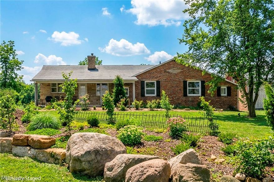 Step into this fully remodeled farmhouse-style home with no expense spared, set on 5.3 scenic acres w/ beautiful frontage and offering the perfect blend of character and modern updates—ideal for those seeking their own private slice of tranquility. Inside, you’ll find luxury vinyl plank flooring throughout and a warm, inviting living space centered around a cozy wood-burning fireplace, while the thoughtfully updated kitchen features rich wood countertops, soft-close cabinetry, and a layout designed for both everyday living and entertaining. A bright sunroom overlooks the property and opens to a spacious deck—perfect for peaceful mornings or evening sunsets. The home includes central air, tankless RO-unlimited hot water system, and two Carrier heating/cooling systems for efficient, year-round comfort, along w/ a partially finished, carpeted basement adding flexible living space. Outside, the property truly shines w/ a covered hot tub, covered front porch, and an impressive orchard featuring peach, cherry, and apple trees. Additional highlights include outbuildings, a two-car garage, pole barn, and a historic brick barn once part of a working dairy farm—offering endless potential for storage, hobbies, or agricultural use. This is a rare opportunity to own a property that combines timeless charm, modern upgrades, and expansive land for your own countryside retreat.
