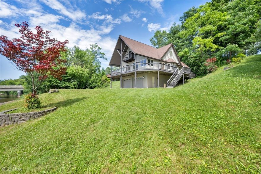 Experience the ultimate in waterfront living with this rare riverfront treasure, offering over 600 feet of breathtaking shoreline on more than 3 private, partially wooded acres. This updated A-frame home seamlessly blends rustic charm with modern luxury, creating a warm and inviting retreat. The spacious first-floor primary suite with a private en suite bath, combined with an open-concept layout, provides effortless flow and comfort for everyday living or entertaining. The stunningly renovated kitchen is a chef's dream, featuring brand-new appliances, stone countertops, a striking backsplash, and the convenience of insta-hot water. New wide plank LVP flooring adds style and durability throughout the main level, while plush new carpeting adds comfort upstairs. Walls of windows fill the home with natural light and capture panoramic views of the river. Step outside to a wraparound, partially covered deck perfect for relaxing, entertaining, or simply soaking in the serene setting. With ample storage for boats, paddle boards, canoes, and all your water toys, this move-in-ready escape is as functional as it is beautiful. A hidden gem unlike any other, don't miss the chance to own this one-of-a-kind waterfront haven!