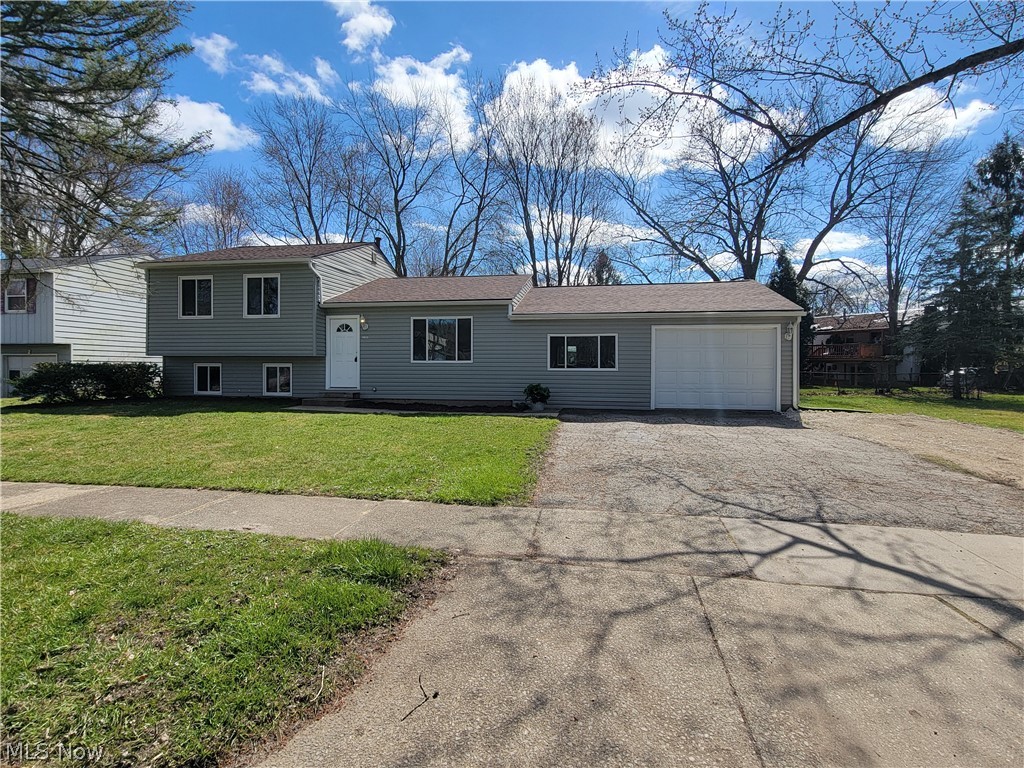 The minute you walk into the front door you can see how clean and well maintained this gorgeous split level is! Open floor plan allows all of the rooms to flow into one another! Sliding glass doors off of the sunshiny dining room that leads to the classy kitchen! Ample cabinet space with deluxe, pull-out shelving in the pantry! Truly a remarkable family room with custom barnwood steps and bench seat, stone fireplace and entry into the oversized one car attached garage with workshop area. The second level has three bedrooms and a full bath. Lower level would make a great rec-room, home office, exercise space or fourth bedroom! Laundry/utility room would make a nice mudroom as it leads out to rear yard where there's a firepit and fenced in yard. Total approximate square footage is 2148. Furnace replaced in 2022 and a new roof in 2019. Fresh paint throughout and carpet installed on stairs and all 3 bedrooms in March 2024. Immediate occupancy! Just beautiful inside and out!!