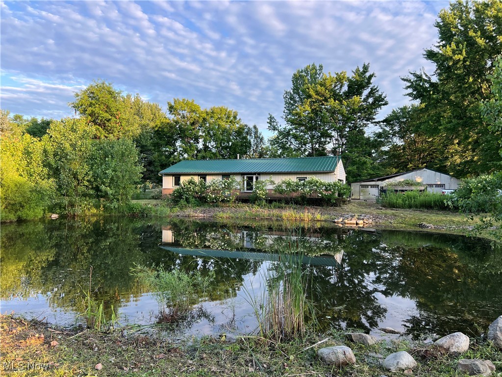 Ranch home overlooking the pond in front yard. Partially wooded. Nice kitchen with dishwasher, range, refrigerator and microwave. Full basement. Wood burner. Outbuilding. The home needs some updating but a great value.