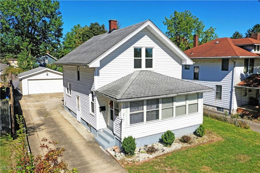 Freshly renovated with tasteful touches throughout, this hot-to-market Youngstown home is waiting for you with two floors of move-in-ready living space! Find that perfect blend of space and efficiency as you explore this surprisingly spacious residence. Located in a quiet neighborhood, this offering is quick to catch your eye with its charming exterior, noted by its enclosed and finished front porch and tidy, stone landscaping. A cement driveway extends past, leading up to a two-car detached garage that overlooks a second, covered rear patio and entrance for day-to-day use. Inside, the formal entry opens to find a large living room as carpeted stairs rise away to find the second story bedrooms. Thick wood trim work adds to the appeal as hardwood style floors run underfoot. Nearby, formal dining joins a gracious kitchen with its stone-look countertops and array of bright white cabinetry. Additional bar top seating doubles as prep space. On the second floor, a pair of generously sized rooms are accompanied by a stunning full bath with its elegant tile work and stone flooring. Down at the basement level, a second full bath is available along with laundry services. Call today to be first through the door!