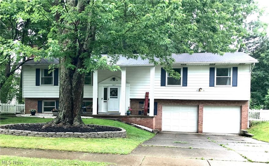 This turn-key Kent, Ohio 4 Bed, 3 Bath huge bi-level is perfectly situated adjacent to Highland Park, effectively expanding the back yard (through picket gate) without the added lawn work! Granite kitchen, with wonderful glass/ceramic backsplash, generous 4-seater bar, has been ingeniously opened up, creating spacious kitchen/living/dining area! All 3 FULL baths have been given facelifts! Original hardwood throughout main level except kitchen. Newer low-maintenance composite deck is IMMENSE & turns entertaining into a cinch! Also from the deck, a view of nature that's peaceful and quieting. Full vinyl picket for fur babies or young ones. On-trend paint throughout! Family room w/ wood burning fireplace makes for a nice winter evening. Comfortable walk to Kent State University! Far enough from downtown to avoid the bustle, but close enough to walk to South side shopping or bike or walk to downtown. Routes 43, 261 and I-76 are all minutes away as are bike trails! Washer/Dryer included her