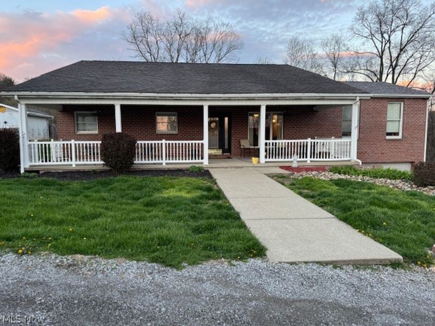 This 4 bedroom, 1 1/2 story home features a brick and vinyl siding exterior, in a prime neighborhood. A large open living and dining area featuring a gas fireplace, designed for modern entertaining with large windows overlooking acres of country living in the hills of WV. Kitchen is equipped with a large island, modern appliances and a walk-in pantry along with a Blackstone griddle. The countertop bar sits 8-10 in the breakfast nook. Spacious main level primary bedroom with large walk-in closet, spa like bathroom with double vanities, separate shower and a soaking tub. Laundry room on main floor. The nice covered concrete porch will welcome you to this home.