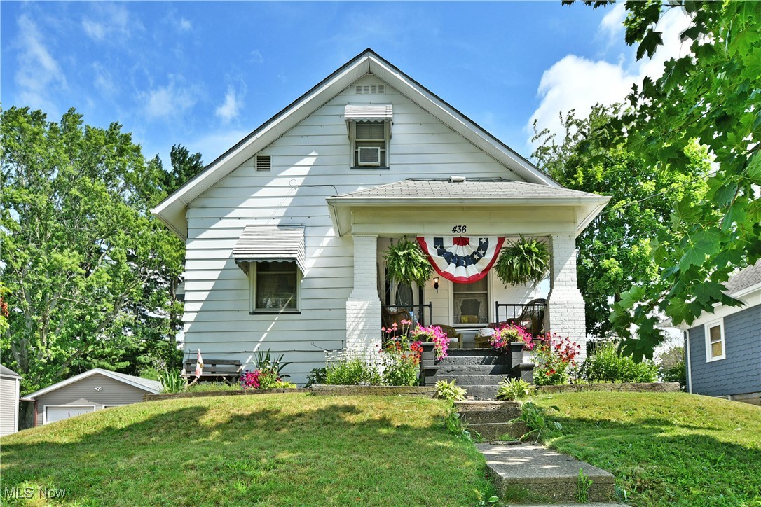 This bungalow style home is cute and cozy inside and out! The covered front porch is large and inviting. Front door leads to the main living area with high ceilings, craftsman style wood work and doors, beautiful hardwood floors and an open layout. Off the living room is a den, that could also function as a bedroom. Updated kitchen with full appliance package and new flooring. The laundry area is conveniently located off the kitchen and the master bedroom and full bath are also on the first floor. Upstairs is a large bedroom that would make a great kids space or guest bedroom. Central air was added in the last 5 years as well as hot water tank updated electrical panel with some new wiring for outlets and recessed lighting. Many wheelchair accessible features have also been added to include a 5 ft wide ramp, grab bars in bathroom and 36 in wide doorways. A new 16x20 concrete patio is a great place to sit and enjoy the outdoors and perennial landscaping. A convenient 1 car detached garage with a lean to storage space for yard equipment completes the package!