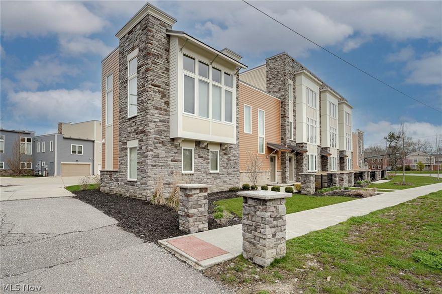 Wow! Move right into this stunning townhouse in Shaker Heights! Built in 2019, this welcoming home features 2 bedrooms, 2.5 bathrooms, spacious sun-filled living areas, a beautiful eat-in kitchen, and more! The front door opens into a nice foyer with the staircase to your left that ascends to the main living area. Here you will find a stunning living room that features a vaulted ceiling, large windows, a gas-burning fireplace, and LVT flooring. The living room is open to the eat-in kitchen that boasts granite countertops, stainless steel appliances, and a breakfast bar. A pantry, storage closet, and a half bath are located just off of the main living area. Down the hallway is the owner's suite that includes a walk-in closet, a large bedroom, and an ensuite full bath with a step-in shower, ceramic tile flooring, and granite-top vanity with two sinks. A convenient laundry closet is located just outside the owner's suite. The first floor includes a large bonus space that is currently setu