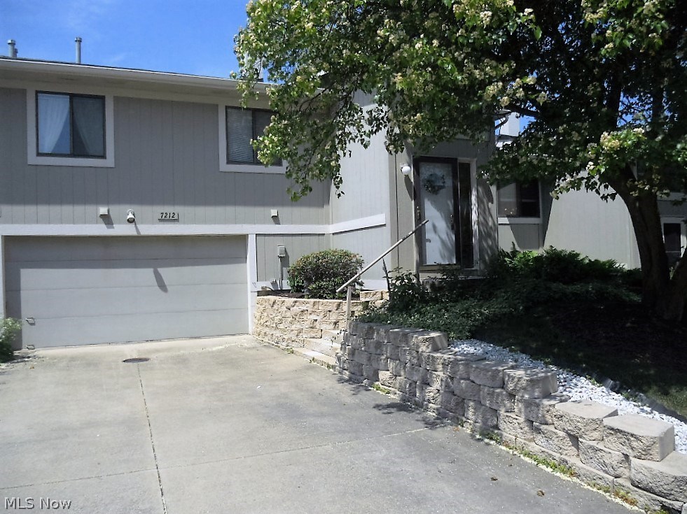 What a beautiful place to live! Brand new ceramic flooring in entrance way. Just a few steps up into the spacious living room with vaulted ceiling. Entire home has been professionally painted with new carpeting throughout. Carpeted dining area adjacent to well planned kitchen. Down the hall are the master bedroom with walk-in closet, second bedroom and full bath. All newly carpeted and painted. Full bath has been completely redone including new bathtub. Large linen closet in hallway. Lower level features a gorgeous, stone, wall fireplace with raised hearth as a beautiful center piece to the room. Beyond this room is a hallway where you will see the half bath. This bath has been completely refinished top to bottom. A few steps further are the door tot he roomy, 2-car garage and also the laundry/utility room which is also a nice size. All complex is well maintained as you can see by the beautiful landscaping everywhere. Additionally, you are just a few minutes from excellent grocery stor