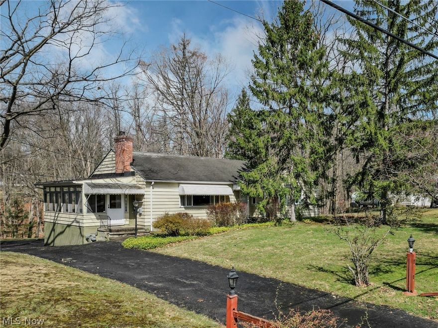 Back on the market through no fault of seller or home.  Buyer's financing did not come through.  Location location location! Attention investors and DIY Owner occupants!  This wonderful 4 bedroom ranch home sits on a quiet lane that ends at the entrance of T.G. Young Park and Recreation Center in desirable Walton Hills! With just over an acre there is plenty of room for your outdoor activities, but not so much land that you'll spend your Saturday on your riding mower.  The back yard is a peaceful paradise with a wooded lot overlooking a seasonal creek below.  Bring your design ideas and update this home inside and out to your own perfect preferences.  Enter through the front door and you'll find a very large living room with a fireplace for those chilly Ohio evenings.  The kitchen features plenty of counterspace, a door to the rear deck and room to add an island if you want to.  The formal dining room has plenty of natural light, and is just off of the spacious side sunroom (which could double as a mudroom) that overlooks the pretty wooded lot.   Four bedrooms and a full bath with separate tub and step in shower complete the main floor.  The laundry is currently located in the large unfinished basement that also serves as walk in access to the two car garage.  Can you envision the potential this home offers??  Owner occupant with sweat equity?  Investor flip?  Home is being sold AS IS, seller will make no repairs.  Schedule your showing now and become the next chapter for this lovely home!