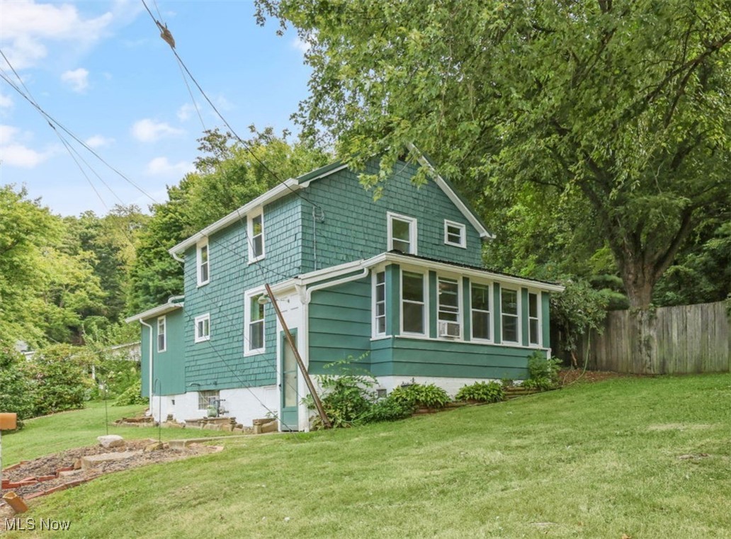 This charming 3-bedroom, 2-bathroom home in the heart of Holmes County offers the perfect blend of comfort, character, and convenience. With inviting hardwood and updated laminate floors, the spacious layout provides an ideal setting for both relaxation and entertaining. The main level features large family and living rooms, one of which could serve as a formal dining area, offering plenty of space for gatherings. A convenient first-floor laundry and a full bath add to the home's practicality. The bright and airy sunroom is a standout, providing the perfect spot for a home office or cozy reading nook where you can grab your favorite book and enjoy the nature surrounding you. Upstairs, you'll find three bedrooms and a full bath, providing privacy and space for all. Updates include all new windows, paint, flooring, and a new furnace. Outside, the property sits on just over a 1/4 acre, with two parcels included, offering ample room for gardening, recreation, and more. The fenced-in backyard provides a private retreat, complete with a lovely patio area, tiered gardens, and so much potential for a peaceful backyard oasis. Additional features include a couple of outbuildings, ideal for storage or workshop, adding even more value to this already fantastic property. Don’t miss your chance to own this piece of Millersburg’s charm!
