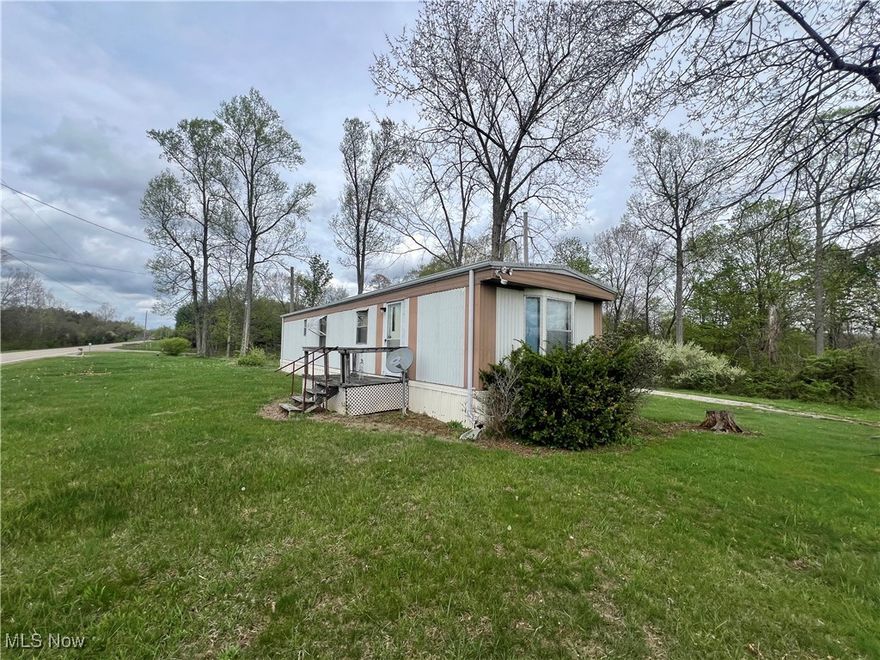 Discover your perfect retreat on this spacious 2.5+ acres of flat lush land with a gentle roll downward towards the back, ideal for living, gardening, or livestock. Imagine your dream garden, nourishing in the large open yard, or your animals grazing peacefully in your own countryside haven. Plenty of rooms for chickens to peck around. Cozy two-bedroom, low maintenance mobile home with easy upkeep so you can enjoy more of what matters. Comfortable living in a serene rural setting. Convenient location, double ended driveway. Stretching the length of the property for easy access and ample parking just off of State Route 78 – quick hassle-free commute. Easy access just past Reinersville flea market site. Public transit available for additional convenience. Additional structures and outdoor fun. There’s a large 30’x54’pole barn. Perfect for extra parking, a party cave, workshop, or archery practice. Smaller wood barn in need of some love great as a hobby space or for livestock. Plenty of outdoor room for campers, RVs, bonfires with friends, or reunions. Whether you’re seeking a peaceful escape, hobby farm, hunting, hideaway, or outdoor recreation haven, this property delivers. Located near multiple outdoor recreation areas, it’s an ideal spot for outdoor enthusiast and hunters alike. Don’t miss your chance to own a versatile, spacious piece of paradise with endless possibilities! Call today to schedule your private tour and make this exceptional property yours!