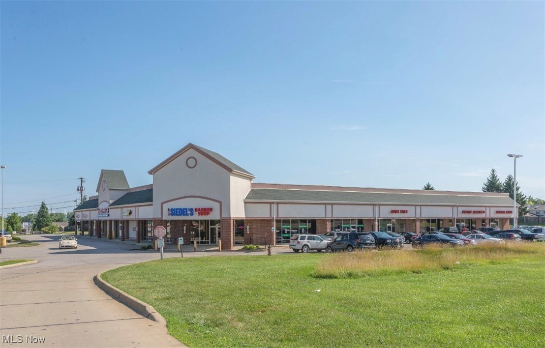 View of commercial location with uncovered parking