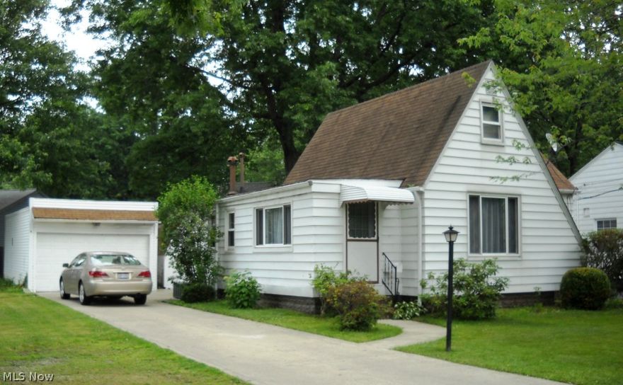 Lovely updated three bedroom Cape Cod home with an additional lot. This home has new carpet, new kitchen, new hot water heater, new electrical including fans, new bath, newer appliances which stay with the home, and newer tilt out windows. Charming great room with fireplace. Outside - a chain link fence, large two car garage with work room, shed and a large yard for a play area or garden. extra lot comes with the home.