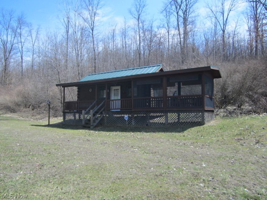 Excellent 10 acre recreation property includes small log cabin, plus additional shower-house cabin, plus large open-sided pole bldg, all with electric. Woods, trails, open field, secluded acreage, fresh water stream, surrounded on Woodbury Wildlife ODNR land on 2 sides. Perfect weekend getaway and fantastic hunting retreat. Mineral rights transfer. Two parcels, owner will split for the right price.