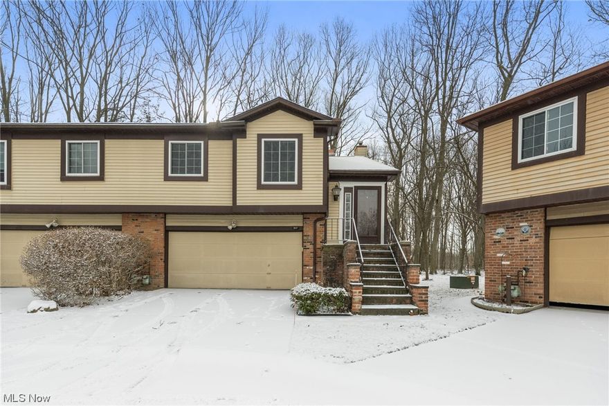 Welcome to 317 Greenbriar Ct #317! Gorgeous fully remodeled two-bedroom end unit overlooking Euclid Creek Reservation Metroparks. An open floor plan greets you as you walk in highlighted by a beautiful mid-century woodburning fireplace, vaulted ceiling with a decorative wood beam, hardwood floors, and sliding door to the rear deck overlooking the yard a perfect place to entertain friends and family. Enjoy cooking in the contemporary kitchen with white cabinets, a quartz countertop, a ceramic tile backsplash, and a double sink; all appliances included. Spacious owner’s bedroom with two closets and access to the rear deck. Owner’s bathroom with a vanity and a walk-in shower with tile surround. A second bedroom and a full bath complete this level. Lower level with a walkout family room with gorgeous wooden ceiling and beams and a wet bar with ganite top. A half bath with a large vanity with lots of storage, a linen closet, and built-in shelves. A laundry area completes the lower level. Enjoy the serene park-like sitting rear yard and patio with views of the wooded area and the Metroparks. Attached two car garage. Recent updates include new carpet in 2023, hardwood floors in the living and dining room, update all bathrooms 4 years ago, updated kitchen 5 years ago. Great location close to restaurants, parks, and shopping with easy freeway access. Make this beautiful home yours, call us today to schedule a time to see it.