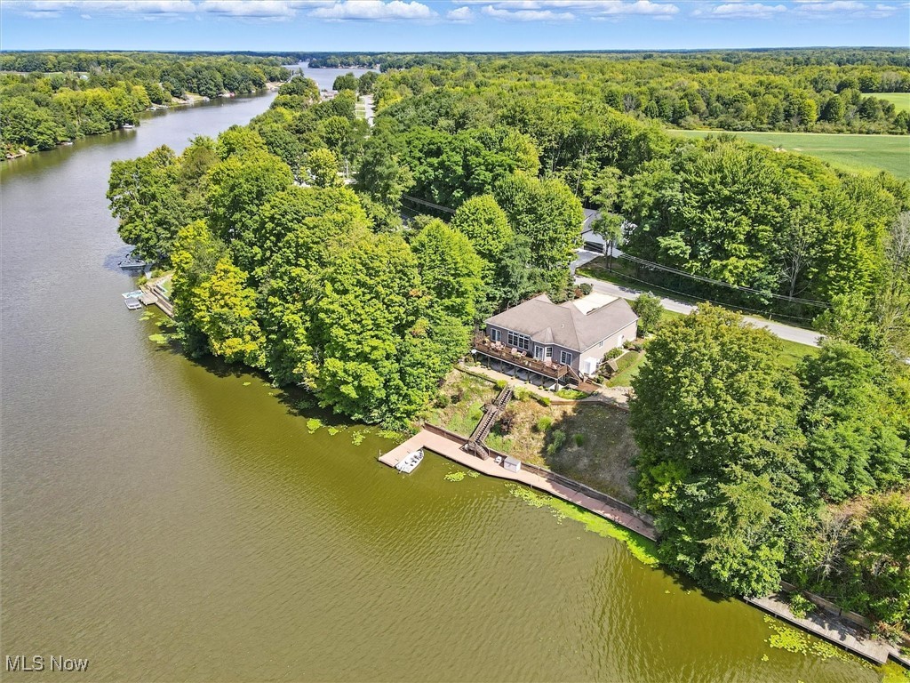 Don't miss this gorgeous Roaming Shores lakefront home with 160 feet of frontage on Lake Roaming Rock. Located just inside the "No Wake" zone, it's one of the best bass fishing lakes in Ohio. Located just a short distance from St. Rt. 11, you have quick and easy access to Cleveland, Erie, Warren-Youngstown, and Pittsburgh. Your new home is really move in ready because it comes furnished. Most of the furnishings stay. This isn't a misprint. Most Everything stays!!!! All you need are the keys. The pictures tell the story of this beautiful, well maintained waterfront home. Four bedrooms with a possible fifth. Three full baths, two on main floor, one in finished basement. Two gorgeous kitchens, one on main floor and one in basement. Two dining areas, one on main floor and one in basement. Two family rooms, one on main floor and one below. Two gas fireplaces. one on main level and one in basement. This home is ready for huge family gatherings. Can you imagine your morning coffee on the expansive deck watching the Eagles fish the lake? Jet Ski lift stays! Riding lawn mower stays! There's a lake pump for watering lawn and plants. It stays! Full-time police! Lake Roaming Rock is great for bass fishing, swimming, boating, jet skis, kayaking, canoeing, and much more.