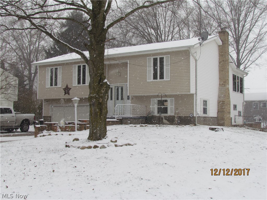 Spacious, and well cared for Bi-level in Suffield/Mogadore with lots to offer. This home is only a minute or two from downtown Suffield, and also the same from Field elementary school. Walking up the few steps, leads you into the kitchen, which has brand new fridge, dishwasher, and microwave, and you will be sure to love the sunroom off the dining room to enjoy the Portage county sunsets. If you have pets, the back yard is all fenced in as well. The master bathroom was just remodeled with beautiful tile work all around. Roof and water tank were replaced in 2010. Home does also have 200amp panel, updated in 2008. In the lower level, there is a rec room where there is a hot tub, and then to walk out the sliding glass door to your back yard, for your barbeques and entertaining your friends and family. (The hot tub is currently not in operation, but can be with a new pump). The lower part of the home, has a very nice family room, with a wood burning fireplace. Sellers had also i