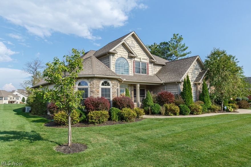 Located in the Blue Heron community, this custom-built, traditional-style Home with first floor Master, is perfect for both entertaining and families. Outside you will enjoy the stunning lake views. With both a composite wood deck and stamped concrete patio featuring a built-in: grill, counter seating, prep area, and fire pit, this backyard was made for BBQing with friends and roasting marshmallows on a nice summer night! Inside features a Chef's Kitchen boasting a multi-level island and top of the line, stainless Kitchen Aid appliances including built-in double ovens and a 6 burner gas range. Black granite counter tops and stone back splash add elegance and compliment the travertine floors. Attached in the open floor plan is the Morning Room, with hardwood floors, surround windows, and French doors that open to the deck. Also in the Morning Room is the floor to ceiling, stone island fireplace which is shared with the 2 story Great Room. The Master Suite is also located on the first fl