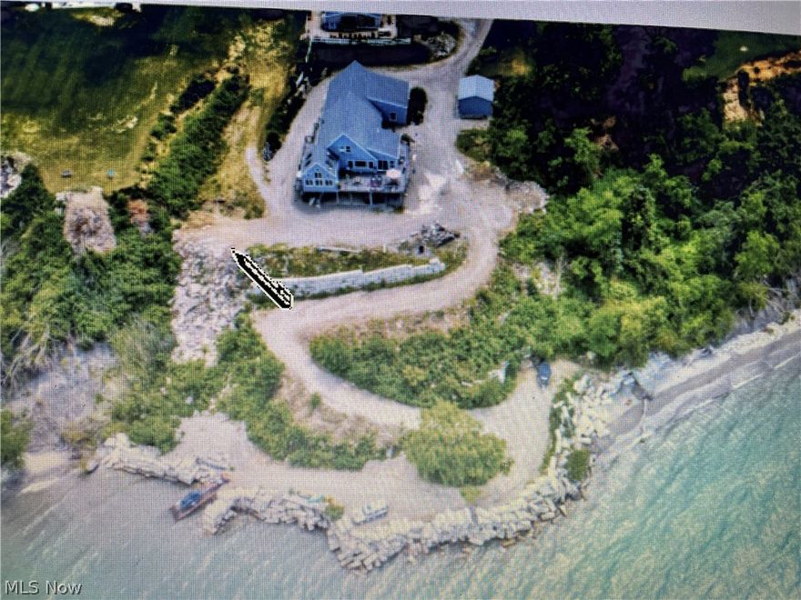 Sit back and relax with views and more views of Lake Erie sunrise and sunsets.  You can see the Ashtabula as well as Conneaut lighthouses from your private deck.  Enjoy the driveway down to the point where you will find a 10' X 40' steel boat ramp.  This Lake home boasts 3 with a possible 4th bedroom and 3 full baths.  There is a huge deck with trex off the sun room that includes a private bar and fireplace with views from almost every room.  There are 5 glass sliding doors leading out to your private paradise on the lake.  There is a 3 car attached and heated garage with a kitchen and 1/2 bath.  Walking out of the full basement with sliding doors you will find yourself on a cement patio with the deck over the top for shade.  In the basement you will find a full bath and a full wet bar plus plenty of room for pool tables or poker tables. You also have an unfinished room that can be used for a great work out room.  There is a gas generator with a transfer station in case the electric goes out.  Owner also installed a full house water filter system. There is a new gas furnace and central air for the house plus a new gas furnace for the garage.  This is a magnificent piece of property and won't last long.