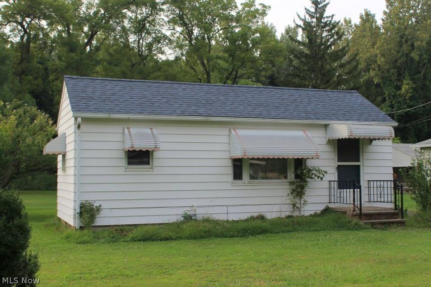 Join the tiny house movement! Bright and airy, adorable home on quiet dead end street.  Large living room, eat in kitchen with breakfast bar, full bath, large laundry/mud room/pantry with floor to ceiling built in storage and counter. Separate utility room and relaxing sun room. Newer carpet, roof, windows, hot water tank. Furnace replaced in 2014. Property backs up to City owned protected green space.