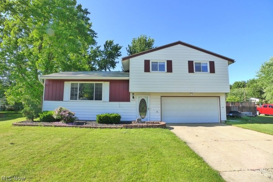 Updated Split with huge fully fenced yard offers so much. Newer roof, windows, HVAC, & electric. Home has many exposed hardwood floors & is fresh & spacious. Lower level Family room has been finished w/surround sound and all speakers & mounted TV stay. Attached 2 car garage. Central AC. Living Room features a cherry real flame fireplace that stays. Formal Dining Room with views of the beautiful back yard. 3 spacious bedrooms, featuring hardwood floors, Master Bedroom has closet with modern barn door! Super cool! There's even a shower in the lower level laundry room! 15x20 concrete patio, 2 sheds stay in the rear yard. One year America's Preferred Home Warranty. This home is move-in ready! An absolute gem!