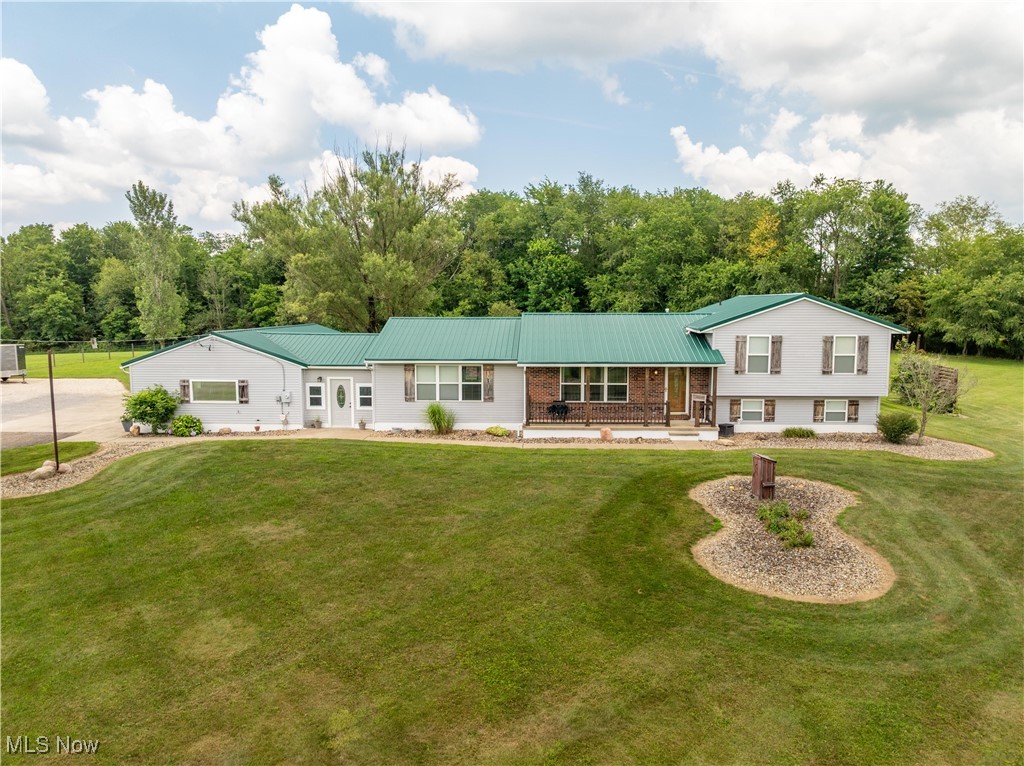 Showstopping Split! This is not your typical split level home! You'll be in love once you pull up the driveway & take in the expansive landscaping! This updated 3-4 bedroom 3 bath country home offers 5.05 acres & the perfect setting for privacy and outdoor activity! The newer metal roof grants excellent curb appeal! Inside no detail has been overlooked! Entering through the massive breezeway, you'll see the family room with a hand made metal railing, The open concept kitchen boasts a breakfast bar, beautiful hardwood cabinetry, pantry & stainless steel appliances. In the dining room, entertaining is a breeze with the built in buffet with more storage! Beautiful LVT floors flow throughout to offer a cohesive look. A sliding glass door leads out to the deck, gorgeous landscaping, koi pond, gardens, fruit trees & grape arbor! The living room is a bright spot to gather in! The upstairs includes 3 newly carpeted bedrooms and 2 full, updated baths. All closets have flexible storage shelving for great organization.The master bath features a soaking tub! All of the woodwork has been painted and upgraded hardware has been installed. The lower level provides a large rec room, office and full bath. This space could easily be transformed into a master retreat with a huge walk in closet. The pristine basement houses the laundry & more storage than you've ever seen! Built in cabinets keep all your extras neatly stored! The side load, heated, 3 car garage again houses an amazing amount of built in storage plus attic access. The back of the property consists of approximately 2 wooded acres with a hunting blind. Entertaining outdoors on the patio with fire pit & grill adds loads of fun! Bring your riding toys, quads and outdoor gear to take advantage of this great home! Roof 2015, other updates have been done since 2018 through present.