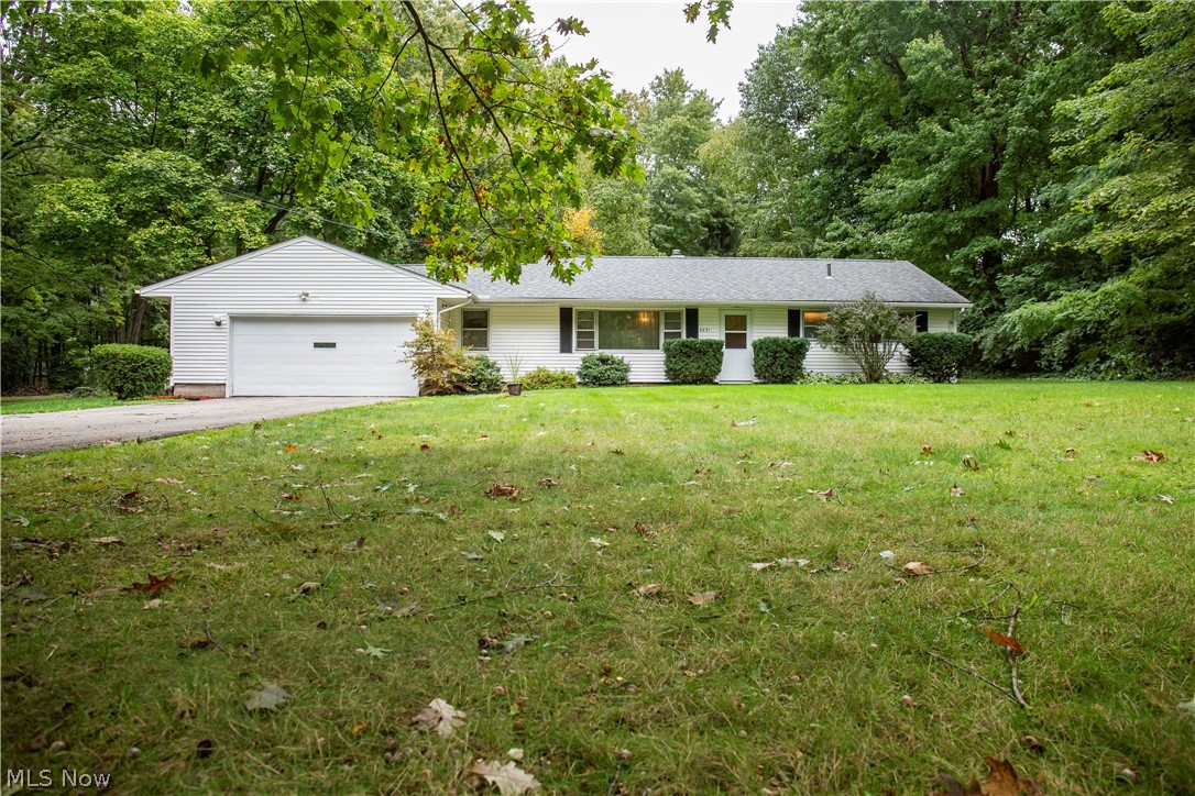 Enjoy the simplicity of single story living in this ranch home located in a quiet neighborhood that is conveniently close to shopping, restaurants and the highway for easy commuting. Walking in the front door leads you into an open area with a closet and built in shelves for convenient storage. The sizable living room gives you plenty of space to spread out while enjoying the large windows that let in an abundance of natural light. Down the hall you will find the generously sized master bedroom and 2 additional bedrooms as well as the full bathroom. The kitchen offers an eat-in space making it easy to enjoy a meal while overseeing the backyard. And just steps away is the laundry room with additional backdoor. Off of the living room is the dining room with hardwood floors, half bathroom, entrance from the spacious 2 car garage with workbench and built-in shelving and back door to the concrete patio with flower pots, poles and sting lighting for a great space to relax outside. While in t