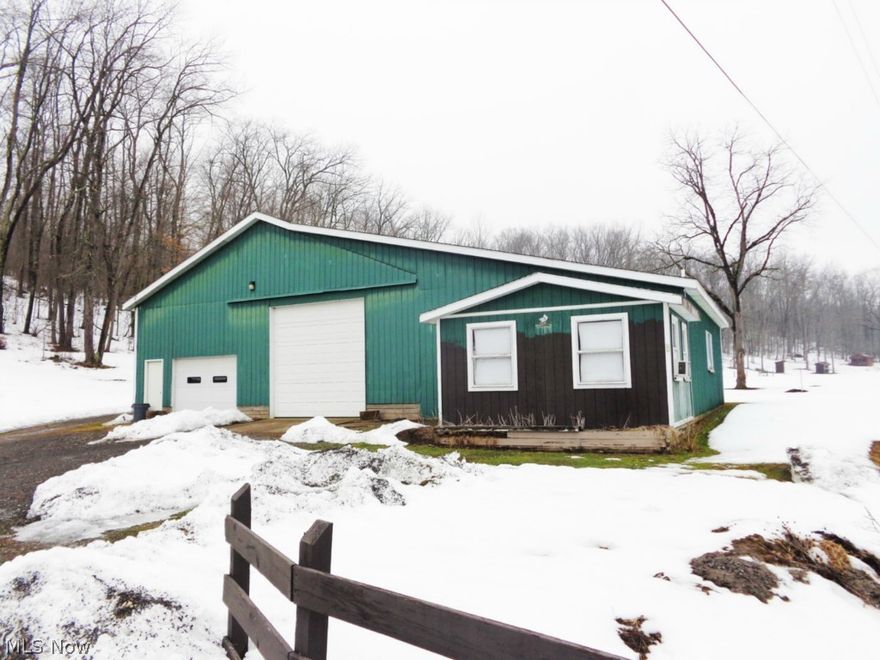 6,000 sq. ft. pole building on 5.6 acres! Great Buy! Beautiful building site.  Building has concrete floors and office, restrooms (not used), 5 garage doors.  Area has no zoning according to Carroll Co.