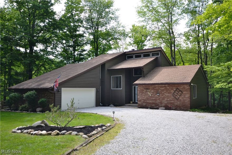 Welcome to Paradise! The private drive leads you to this beautiful, landscaped home nestled back on a private, 3+ acre setting w/scenic water views. Inside & out this home is crafted for comfort & style. The 2-story great rm welcomes you w/vaulted ceilings, floor-to-ceiling brick FP w/gas insert & a wall of windows providing ample natural light. The open concept kit offers stainless steel appliances, large eat-in area, pantry & lots of counter space. The sliding door off the kit opens out to the lg deck, which spans the entire back of the home, perfect for outside dining experiences & entertaining. Two bedrooms on the main floor, full bath & large laundry rm w/lots of storage space complete the main level. Escape to your private 2nd-floor master suite featuring a brick fireplace w/gas insert, built-in shelving, his & her closets & a slider leading out to your own private deck. The ensuite offers 2 sinks, a separate rm w/the toilet & shower & additional storage space or 3rd closet. The