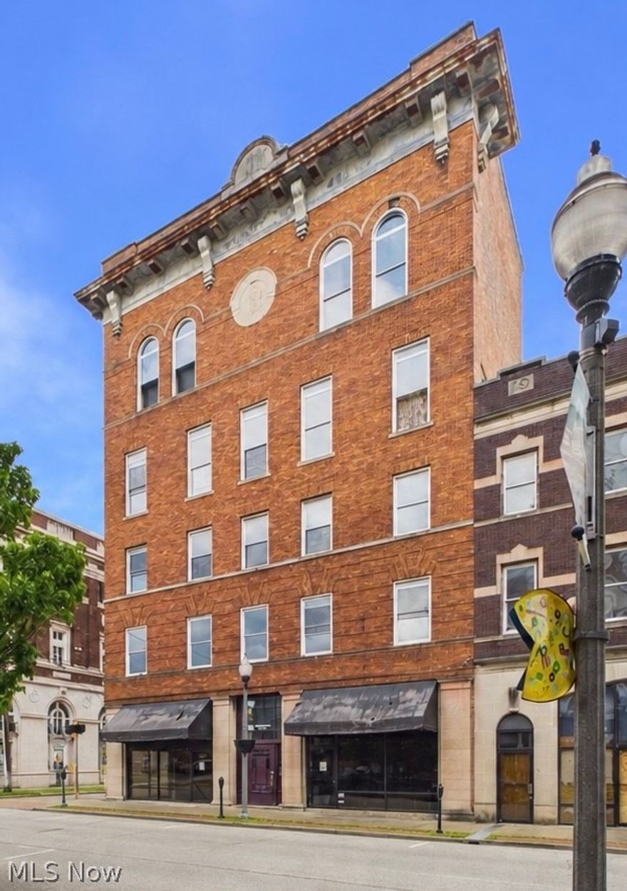 This stately 5 story brick 1912 building stands proudly in the heart of downtown Parkersburg.  With roughly 5640 square feet on each floor, you have over 28,000 sq ft for your imagination to roam.  The first floor features two separate storefronts.  Though the building is currently vacant, one half of floor one was most recently a tattoo shop spanning the entire length of the building with several open top bays. The second floor is divided into 4 apartments with 2 bedrooms each. Third floor is also divided into apartments.  The fourth floor is almost completely open with a ballroom feel. Each floor has beautiful views out on to Market Street.  Basement access from multiple points in the building for lots of storage. Renovate the current floor plan or completely make it your own.  The building needs electrical and plumbing reinstalled, and is priced to leave room for your revitalization dreams.  There is so much potential and a myriad of options for business or community ventures.  Situated in a high visibility location with many frequented restaurants, museums, theater and entertainment establishments steps away, and hospital and other businesses close by.   Call your real estate professional to set an appointment to see for yourself what the future could hold.