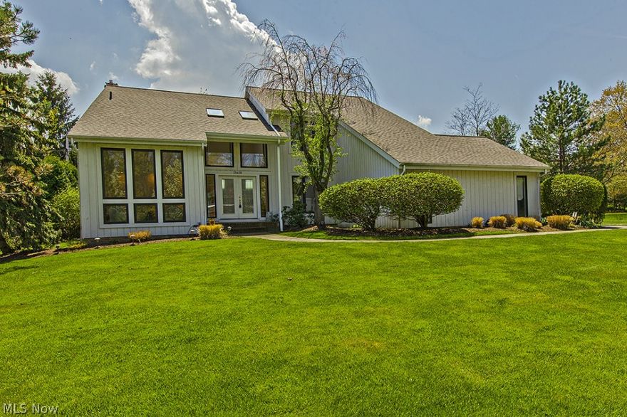 You will love the crisp and classic appeal in this beautiful home set on a sunny block in Beachwood. Walk through the front door and be greeted by the striking two story foyer that floods the front of the home with natural light. Step down into the living room with wall to ceiling windows. An inviting family room with a curved brick fireplace and hardwoods leads to the back deck, perfect for relaxing and unwinding. The kitchen exudes traditional grace, equipped with plenty of cabinets, tile backsplash, and an oversized center island with a counter-top stove. Two updated half bathrooms round out the first floor. The upstairs showcases a master suite with hardwood floors, a walk-in closet, as well as an elegant master bathroom featuring a glamour tub, separate vanities, a walk-in shower, and skylights. Three generously sized bedrooms and a full bathroom completes the second floor. The lower level recreation room boasts expansive space and is perfect for an additional living space. Outsid