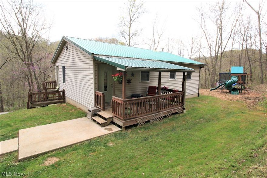 Tucked away on 12.59 acres which are mostly wooded. A hunters dream to hunt on your own property.  This home offers an eat in kitchen with newer appliances, open concept floor plan, living room, 3 bedrooms, 1 full bath, spacious walk out full basement that could be finished into more living space. Large covered back deck.  New metal roof May 2018. Property has two heating sources. Electric forced air or wood burner that is already vented in to the duct work.  30 x 24 Pole barn with concrete pad,electric and plumbed for water but not connected. Only a few minutes from town, Franklin Local Schools. This property is a rare find and will not last. Contact the listing agent for more details.