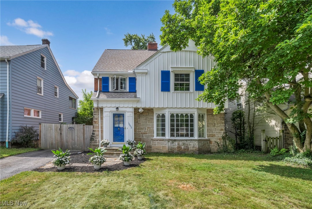 Step into the charm of this stunning all-brick colonial home, nestled in a quiet, walkable neighborhood just minutes from University Circle and hospitals. Offering spacious bedrooms, including a finished attic with a bonus bedroom and updated bath on the third floor, this home provides ample space for both living and entertaining. The original slate entry foyer welcomes you, leading to a beautifully updated kitchen featuring white cabinetry, Corian counters, and tile flooring, with all appliances included. The cozy living room boasts a wood-burning fireplace and bay window, while the dining room features built-in cabinets and French doors that open to a screened sun porch. Additional highlights include hardwood floors throughout, a cedar closet on the second floor, and a finished lower level recreation room with a second wood-burning fireplace. Recent updates include a brand new roof (2023), newer windows (2011) with a transferable lifetime warranty, and a security system. The home is equipped with smart features and offers a two-car garage with a loft for extra storage. With easy access to dining, shopping, and entertainment, this colonial home offers the perfect blend of convenience, charm, and modern amenities.